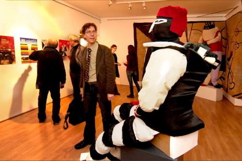 Opening of the exhibition of costumes for Victory over the Sun by Galina Gubanova (Kerri Kotta looking at a costume of the Futurist Strongman). Photographer: Harri Rospu. 